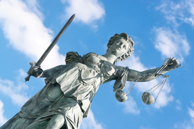Statue of Liberty with a cloudy sky in the background.
